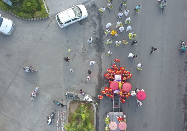 Picture from the drone while the family and monks are walking behind the coffin
